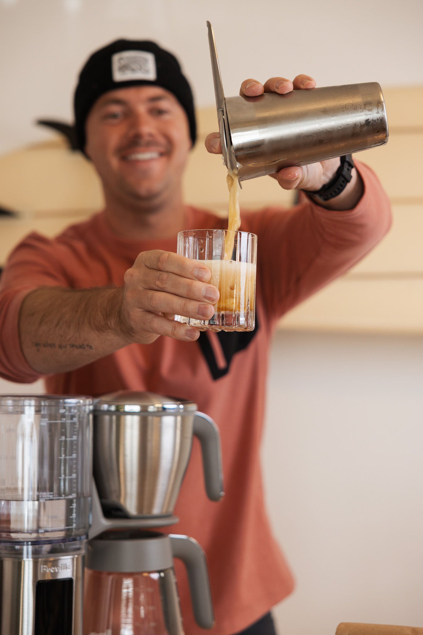 Person pouring coffee from a shaker into a  glass.